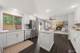 Fully remodeled kitchen with quartz countertops and stainless appliances.