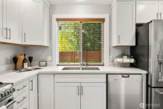 Picturesque window overlooking the fully fenced backyard.