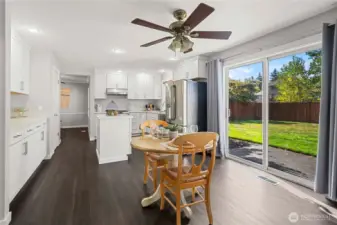 Breakfast nook off kitchen, sliding glass door leading to leveled backyard.