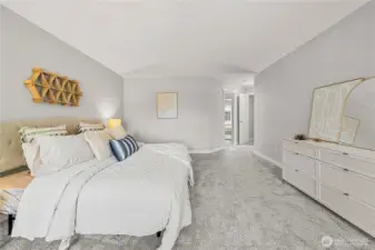 Primary bedroom that easily fits a King sized bed plus dresser and more!