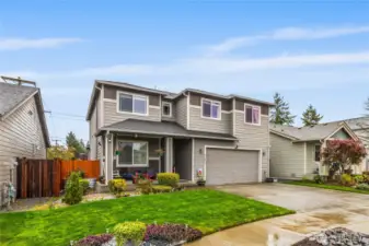 Side view showcasing manicured lawn, privacy fencing, and clean exterior finishes. Pride of ownership shines through every detail.