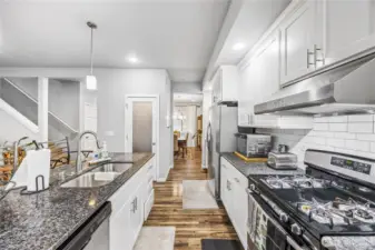 Spacious kitchen with oversized island, pendant lighting, and breakfast bar seating