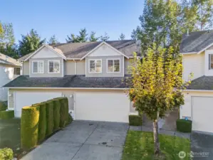 Greeted by a shrub-lined driveway to offer separation and a bit of privacy from the other side of the attached townhouse. 2-car garage plus driveway parking space