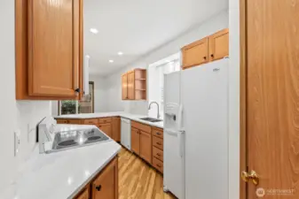 Kitchen with updated countertops bringing brightness to the space.