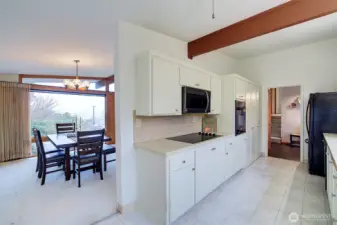 Front entry can be seen from the kitchen. The stairs go up to bedrooms and a full bath.From the kitchen nook you can see into the dining room as well.