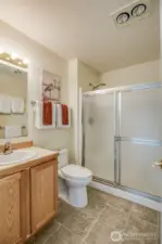 Bottom floor 3/4 bathroom located just outside primary bedroom door.