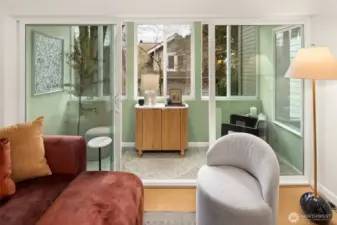 One of our seller's favorites -  this light-filled sunroom is perfect for reading, exercising, or working from home with treetop views.