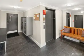 Secure lobby with elevator access, nearby stairwell (just to the left), and a direct interior door to the covered, gated garage - makes coming and going both easy and protected.