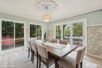 Dining room with folding doors to deck that runs the length of the home.