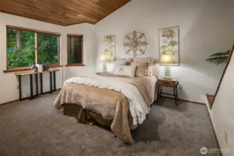 The primary bedroom enjoys high ceilings and lots of natural light.