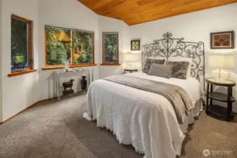 The second of three bedrooms upstairs with private and lush views.