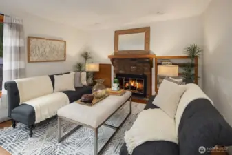 The main level dining room with cozy wood burning fireplace.