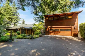 No maintenance front yard has artificial grass on east side of home. Detached garage has exterior stair case to studio space