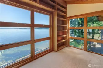 upper level library space is comfortable with even more custom wood library shelving