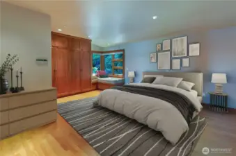 Virtually staged Primary Bedroom has corner lounging space and an incredible amount of built-in storage.