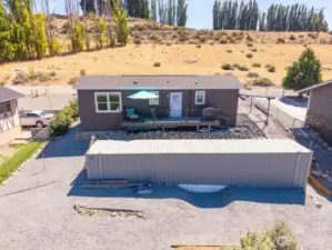 Aerial view of back of home with storage container.