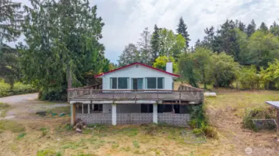 While this home needs significant renovation, its two distinct living areas, each with its own kitchen and living room, are ready to be transformed by your vision.