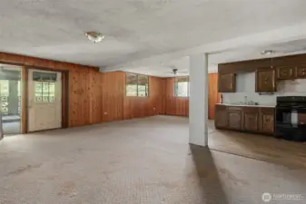 Lower level with family room, dining, and kitchen — the perfect canvas for your next flip or future family home with MIL possibilities.