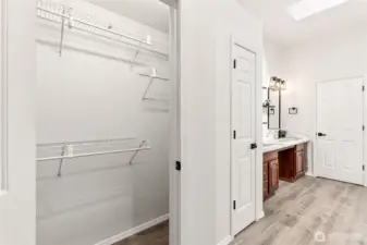 Primary bathroom entrance and "his" closet