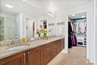 Primary bath with Quartz counters, heated tile floors & floating vanity with dual sinks