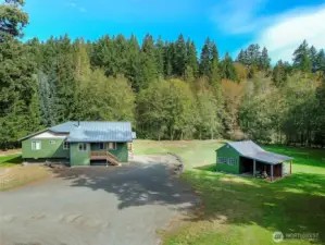 Level sunny location with 250ft of secluded river front on the Little Quilcene River.