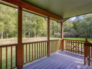 Cover back porch to relax and take in the sounds of the Little Quilcene River.