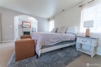 lovely primary suite with a sitting space and fireplace