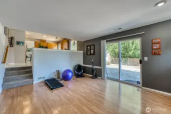 The slider opens to a spacious patio and elevated deck, with a peek-a-boo view of Seattle.