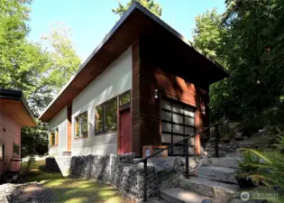 Spacious shop-like garage with tall door for boats, wired for EV charger, light and bright space perfect for artists and hobbyists of all sorts!
