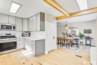Fully remodeled bright, modern kitchen with Thomasville soft-close shaker cabinetry, updated cabinet hardware, Carrara quartz countertops, LG stainless appliances with dual ice maker, and warm wood accents.