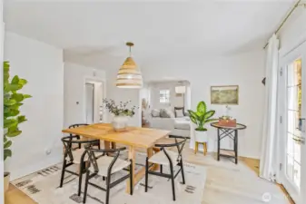 Gather around the table! This airy dining room opens to the kitchen and patio for easy everyday living.