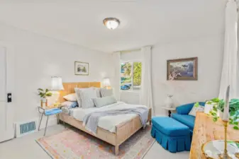 Bright main floor bedroom with neutral tones, dual-pane windows, and versatile use as a guest room, nursery, or retreat.