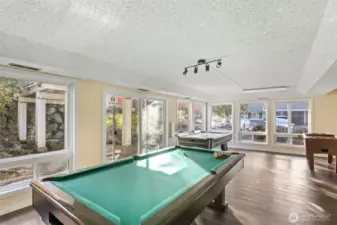 Game room in lower level of clubhouse with outdoor patio featuring privacy and koi ponds