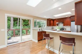 Updated kitchen with slab granite countertops and newer stainless appliances