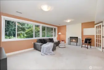 Fireplace on lower level and French doors leading to bedroom.