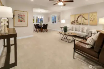 Living and dining rooms from the entry way. Notice the recessed lighting, neutral colors, and lots of space to gather.