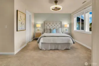 Spacious primary suite is quiet at the back of the home. Walk-in closet is on the left.