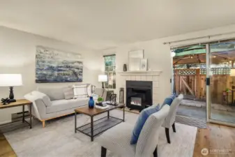 The living area features a wood burning fireplace and access to the fenced yard.