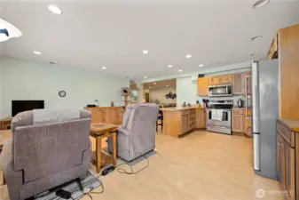 Looking from the entry doorway into the kitchen, common area with Living room in the background.