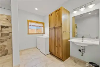 Further down the hall to the rear of the house, the laundry area along with a large walk in shower & wheel chair accessible sink.