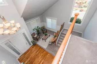 View from second floor looking at formal living and entry.  Lots of architectural touches, hardwoods, newer carpet, vaulted ceilings and natural lighting
