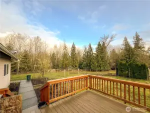 View off of deck. Poured sidewalk for easy access to garage through the man door.