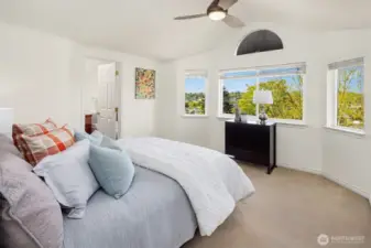 A room with a view! The light and bright primary suite has vaulted ceilings, a walk-in closet, and an attached bath. Don't worry, there is AC (new in 2021).