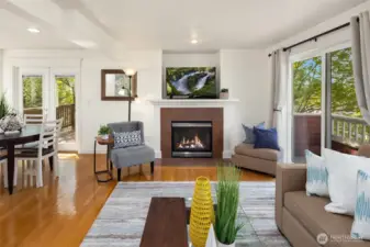 Another view of the light-filled living room and the gas fireplace.