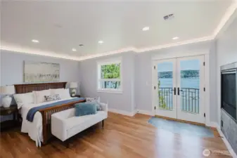 The very spacious primary bedroom with double doors out to the balcony.