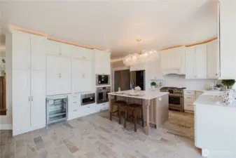 The kitchen is a chef's delight with 2 refrigerators, 6 burner gas stove, farmhouse sink & touchless faucet. Miele appliances, 2 baker prep stations, built in coffee maker. All this and a sweeping view of the Sound and Mt. Rainier.
