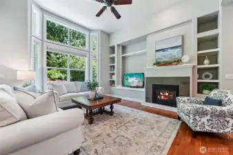 The gas fireplace is flanked with display shelves and there is room for a full size TV! The gas fireplace has a mantle and contemporary surround.