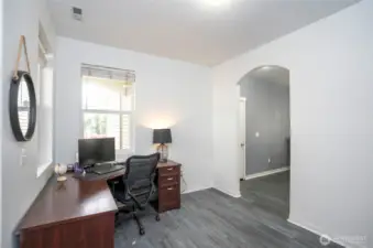 Another view of the flexible multi-purpose room, with the dining room showcased through the elegant archway.