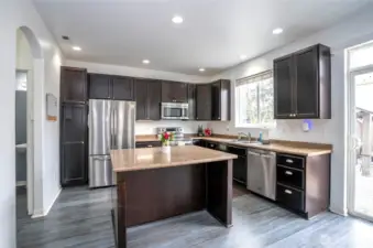 The island kitchen offers generous counter space for meal prep and casual seating—perfect for quick bites or gathering with family and friends.
