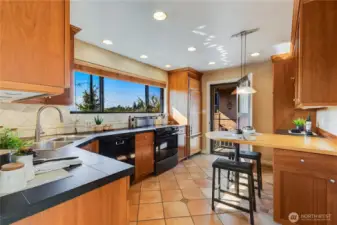 A convenient feature of this kitchen is the side door with outside access. This view shows the door open.